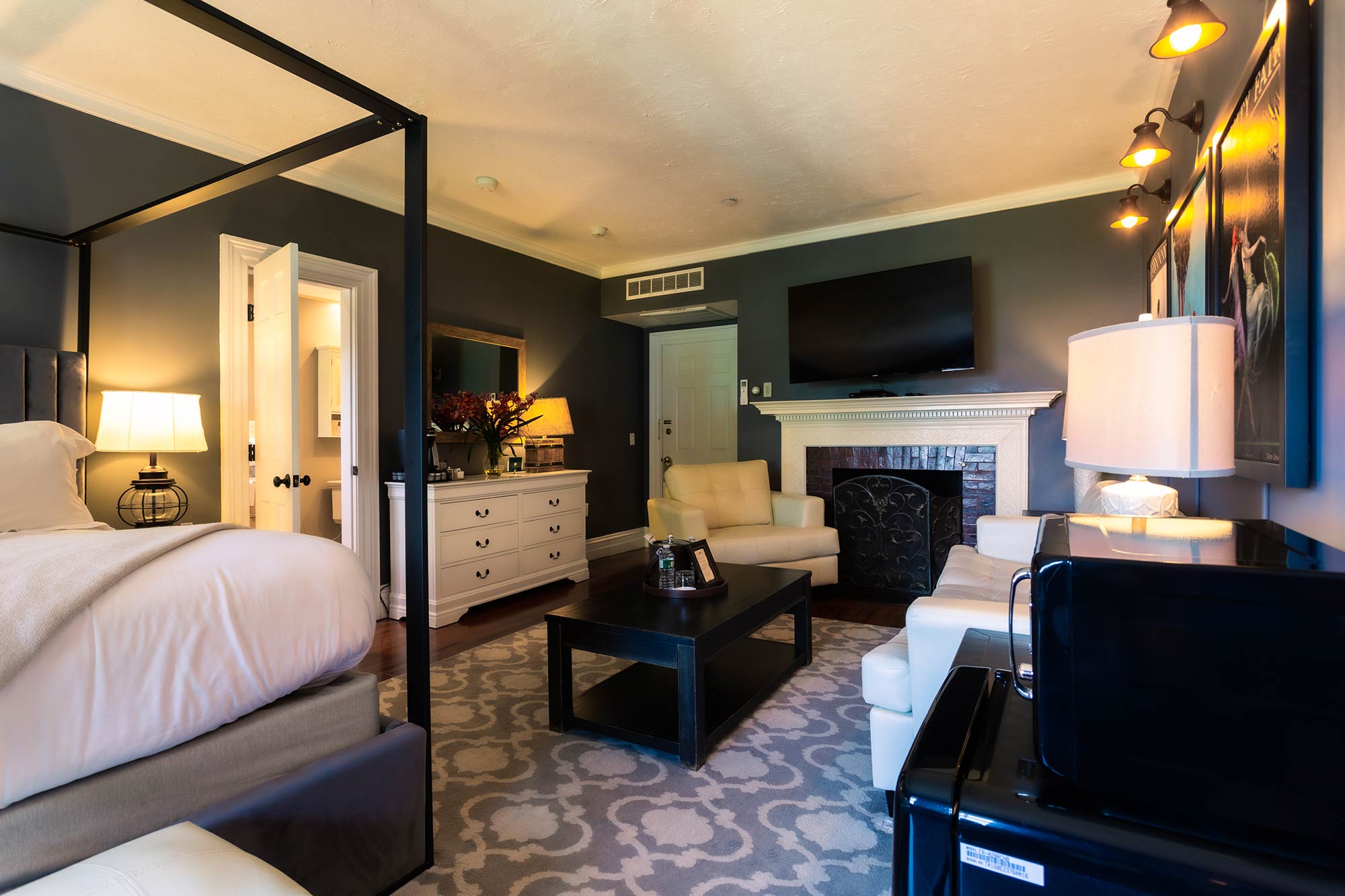 Hotel suite with seating and fireplace.