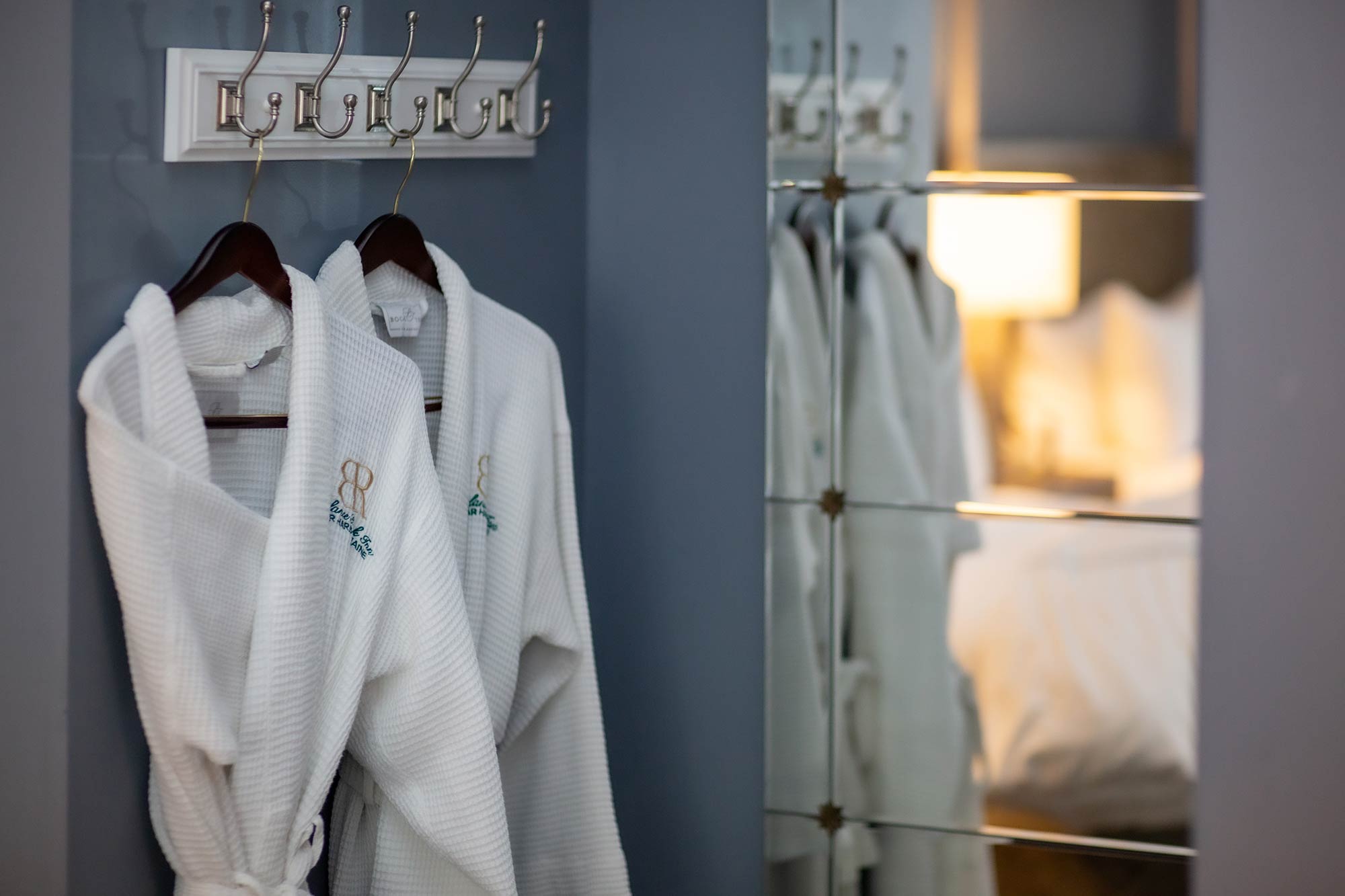 Bathrobes hanging in a hotel room.